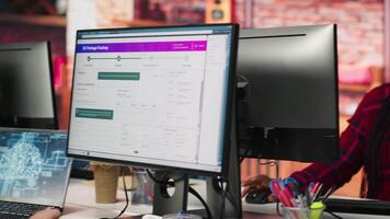 Call center worker tracking shipments at work, looking at computer screen, handling delivery delays. Customer center agent uses software to locate clients packages and provide status updates, camera A video