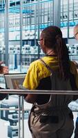 Vertical Engineers talking with manager overseeing smart photovoltaics factory, looking at system performance. Workers receive feedback from solar panels plant supervisor, tracking energy production, camera A video