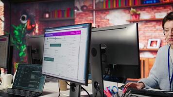 Teamworking cheerful call center agents tracking shipments in office. Upbeat customer center colleagues use software to locate clients packages and provide status updates, camera B close up video