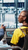 Vertical Manager overseeing industry 4.0 industrial plant gives instructions to workers designing machines using CAD software. Smart factory supervisor tasks engineers to develop automation equipment, camera A video