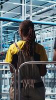 Vertical Manager supervising photovoltaic smart factory workers designing production lines in CAD software. Industry 4.0 solar panels plant team leader overseeing employees optimizing floor layouts, camera A video