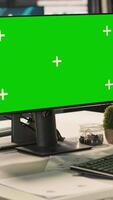 Vertical Office clerk working on green screen mockup PC to hit key performance targets for revenue and profitability. Employee at chroma key computer desk doing research analysis, camera A video