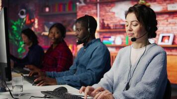 Friendly customer support workers respond to customers inquiries about products or services. Cheerful call center agent in office providing accurate and satisfactory information to customers, camera B video