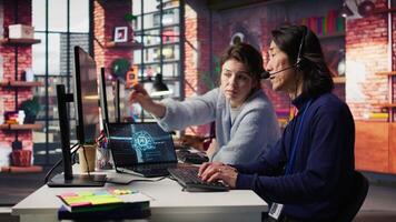 Call center team leader supervising agent helping customers regain access to accounts and devices. Customer center manager overseeing intern assisting clients needing help resetting password, camera B video