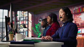 Call center admin team working together to provide live chat support, handling clients complaints. Teamworking colleagues in office dealing with unsatisfied customers, providing solutions, camera B video