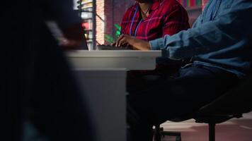 Call center coworkers brainstorming how to answer customers, using AI chatbot. Team of agents doing customer service job using artificial intelligence, working together, camera B video