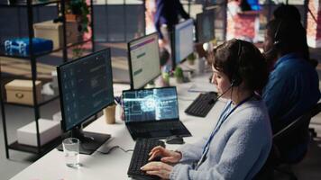 Call center worker in office uses AI LLM assistant to reply to customer queries. Woman doing customer service job generating automated responses to clients using artificial intelligence tech, camera B video