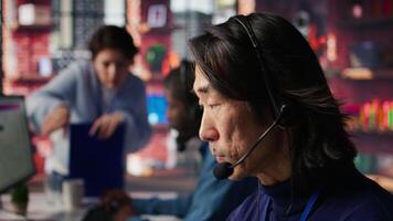 Team leader overseeing work done by call center agent tracking shipments in office. Customer center manager supervising worker locating clients packages and provide status updates, camera B video