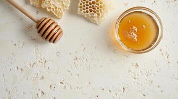 Fresh honey with dipper and honeycomb on textured surface photo