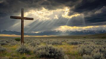 Wooden cross in mountain landscape under dramatic sky photo