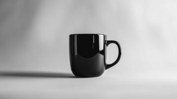 Black ceramic mug against minimalist light gray background photo