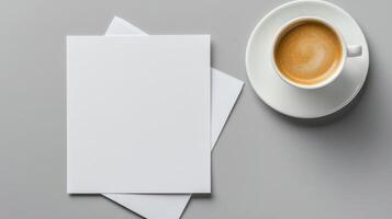 Blank white stationery papers and coffee cup on gray background photo