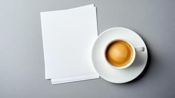 Espresso in white cup on gray surface with blank papers photo
