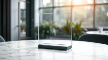 A glass display on a table in front of a window photo