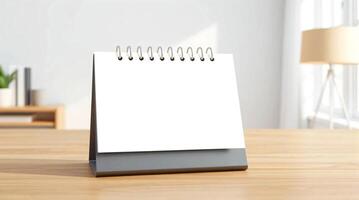 A blank calendar on a desk in front of a window photo