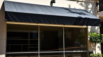 A black awning is hanging over a building photo