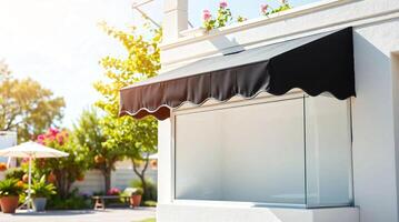 A black awning is hanging over a white building photo