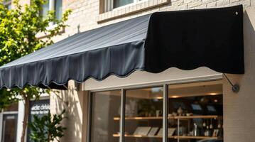 A black awning is hanging over a store photo