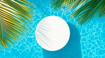 A white round table in a pool surrounded by palm trees photo