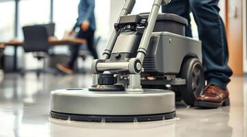 A man is cleaning a floor with a vacuum cleaner photo