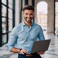 Smiling businessman with laptop in office photo