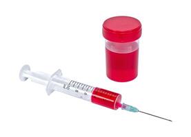 Syringe with red vaccine isolated on a white background photo