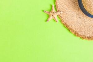 yellow retro straw with seastar top view with copy space. summer concept on green background photo
