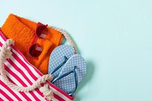 Summer bag background wcopy space. Flat lay photo on color table, travel concept. Free space for text, mock-up