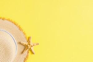 yellow retro straw with seastar top view with copy space. summer concept on yellow background photo