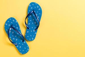Blue flip flops yelow Background. Top view with copy space photo