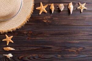 Beach hat with seashells brown wooden table.summer background concept with copy space top view photo