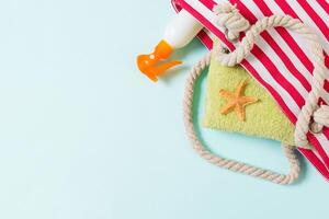 Summer bag background with copy space. Flat lay photo on color table, travel concept. Free space for text