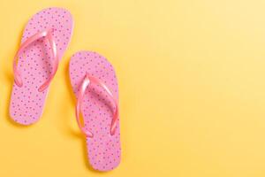 Pink flip flops on Background. Top view with copy space photo