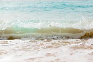 Close up sea waves with splashes on sand beach. photo