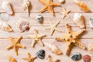 Starfish and seashells background on a wooden table top view, flat lay photo