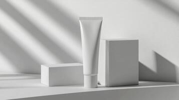 A tube of cream and a box of cream on a table photo