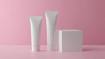 Two tubes of cream on a pink background photo