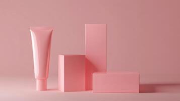 A pink tube of cream and three boxes on a pink background photo