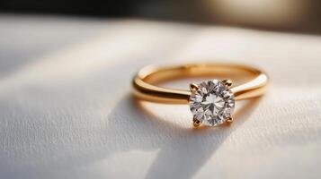 A diamond engagement ring on a white cloth photo