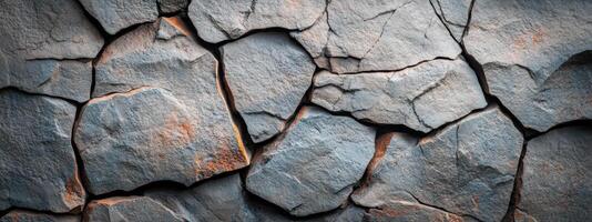 A close up of a stone wall with cracks photo