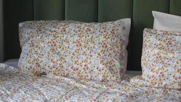 Making a cozy bed with fresh linens and floral patterns video