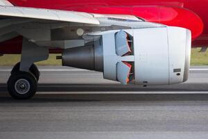 Narrow-body airplane engine in reverse closeup, side view. Backward thrust of the aircraft engine photo