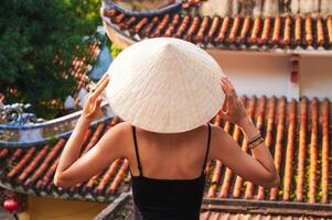 back of a woman tourist traveler at temple on the Buddhist pagoda in Da Nang in Vietnam. Travel and tourism in Asia photo