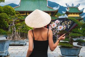 woman tourist traveler at Buddhist temple at Linh Ung Pagoda in Da Nang in Vietnam. Concept of travel and tourism in Asia photo