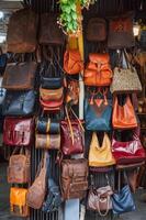 leather bags, belts and accessories on counter in a shop at a street market in Hoi An in Vietnam in Asia photo