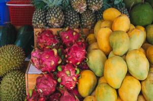 An assortment of various tropical exotic Asian fruits on the counter in store in Vietnam in Asia photo