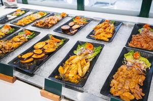 Asian buffet in hotel in Asia. Vietnamese food meat, seafood and vegetables at self-service restaurant for breakfast photo