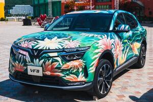 Modern Vietnamese Vinfast VF8 electric car painted with airbrushing and graffiti is presented on Vinpearl Island in Nha Trang. Nha Trang, Vietnam - March 6, 2025 photo