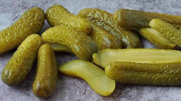 Pickled cucumbers on a gray background video