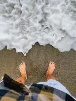 First-person view. Standing barefoot on warm sand, barefoot sensation meets ocean breeze, moment enhances connection to nature, barefoot steps embrace tranquility of shore. Feet sink, beach sand photo